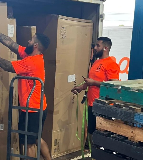 Crew loading a truck with large boxed items