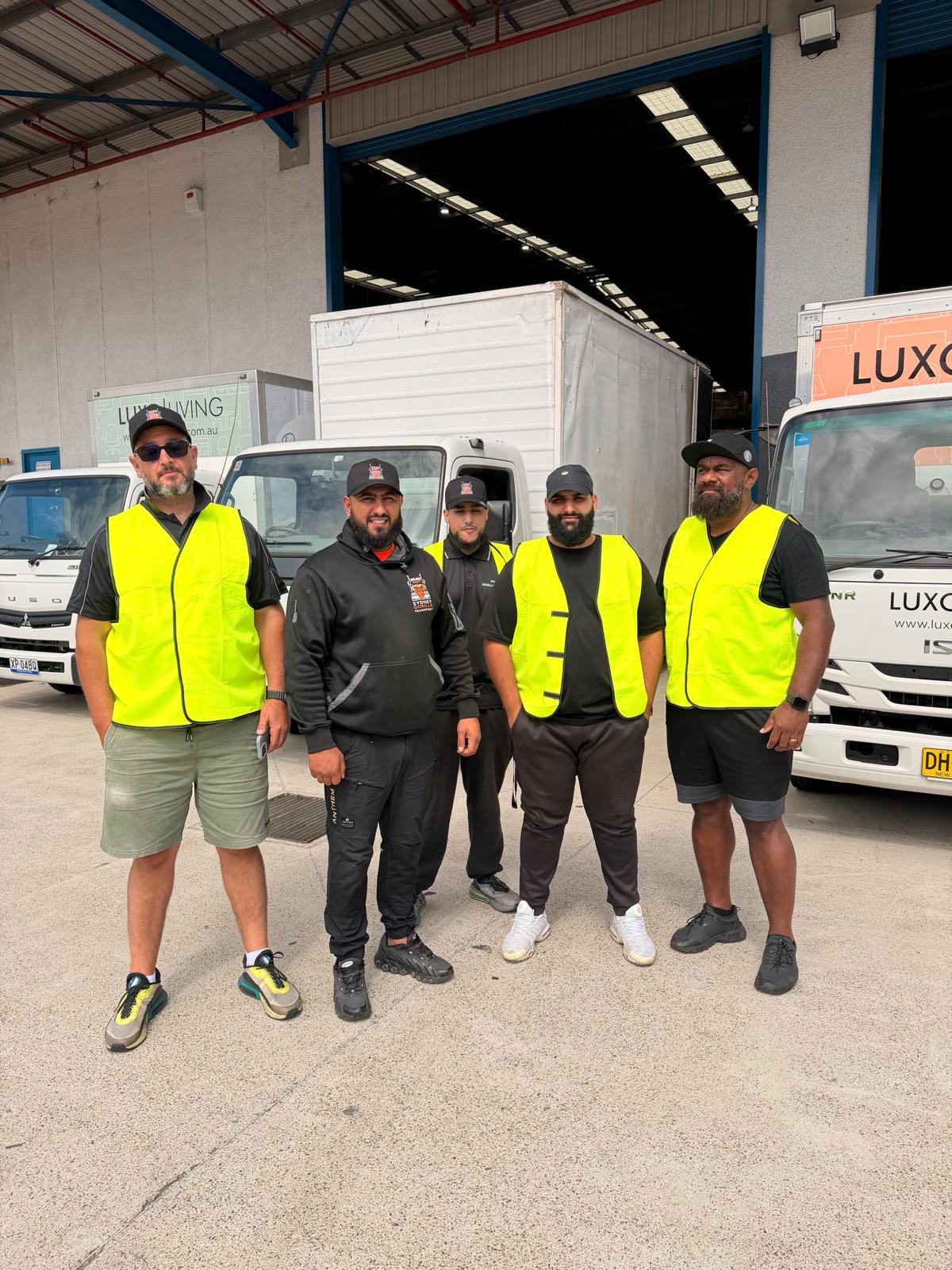 Sydney Gorilla Transport crew standing together in front of moving trucks